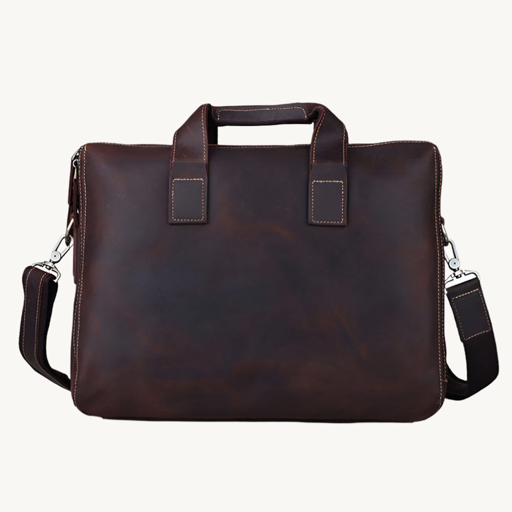 Brown leather briefcase with shoulder strap on a white background